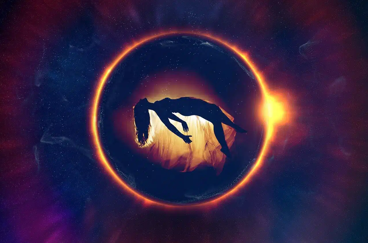 Silhouette of a woman floating horizontally within a glowing ring of light, surrounded by a cosmic background, symbolizing a spiritual or out-of-body experience.