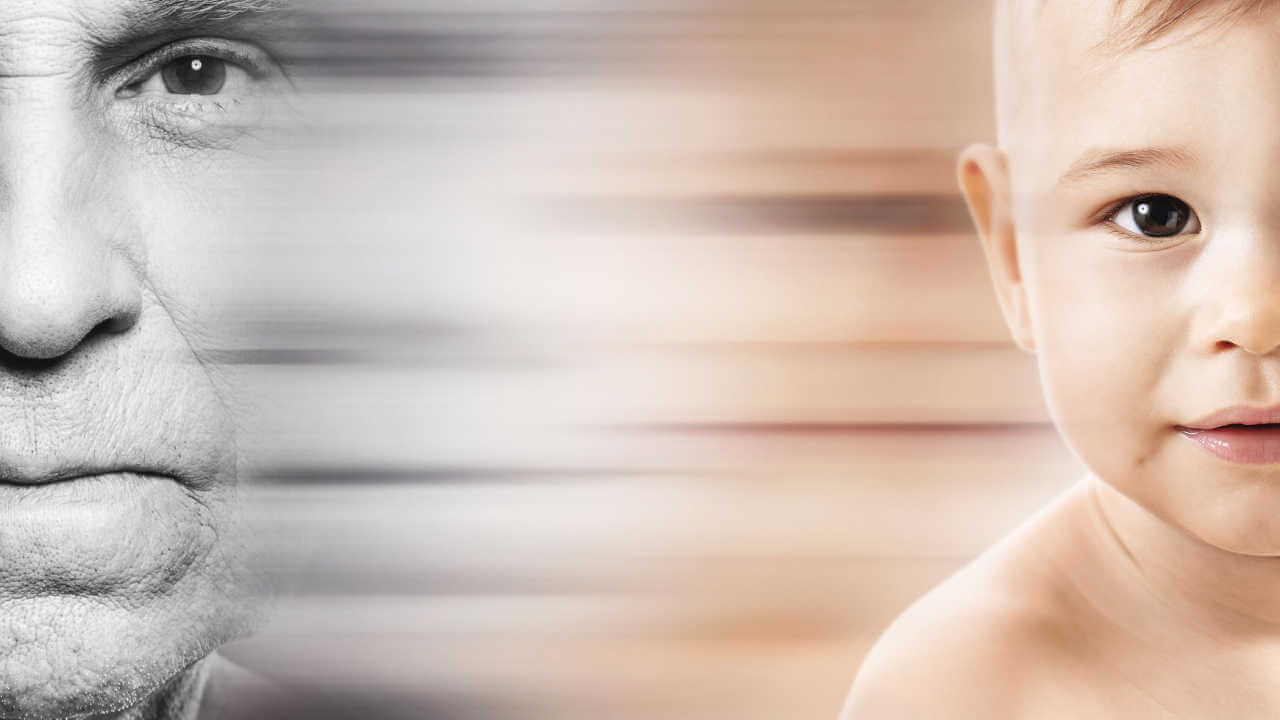 Half of an elderly man's face in black and white next to half of a baby's face in color, with a smooth transition effect between the images.